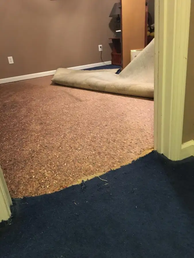 Carpet pad removal revealing water damage during Drying & Dehumidification in Fort Bliss